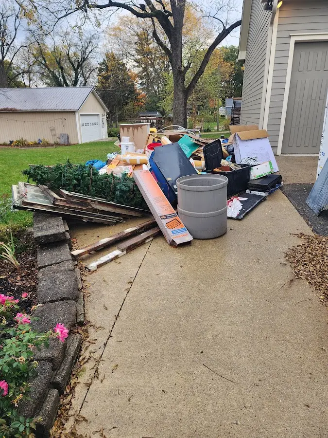 Dumpster being loaded with debris for Estate Cleanout Dumpster Rental in Willow Oak